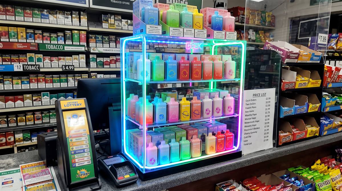 Convenience store checkout with a lighted disposable vape display case
